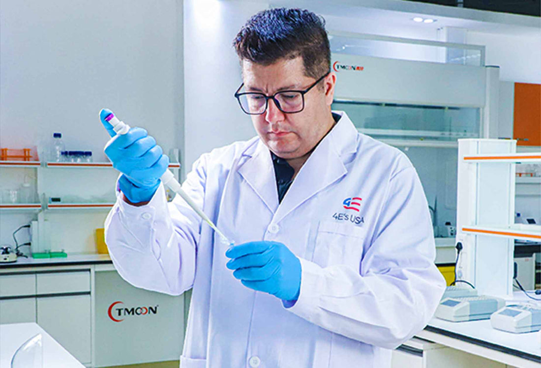 A researcher using a Four E's USA pipette to transfer liquid in a laboratory.