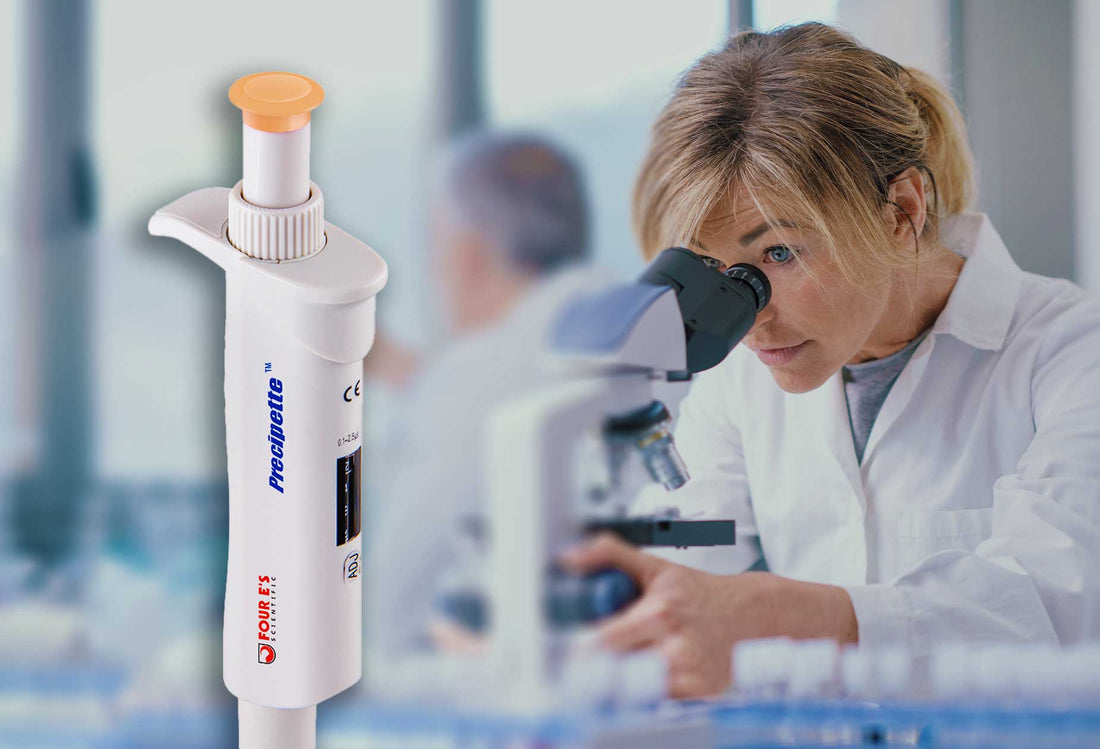 Scientist looking through microscope with a Four E's USA pipette displayed.